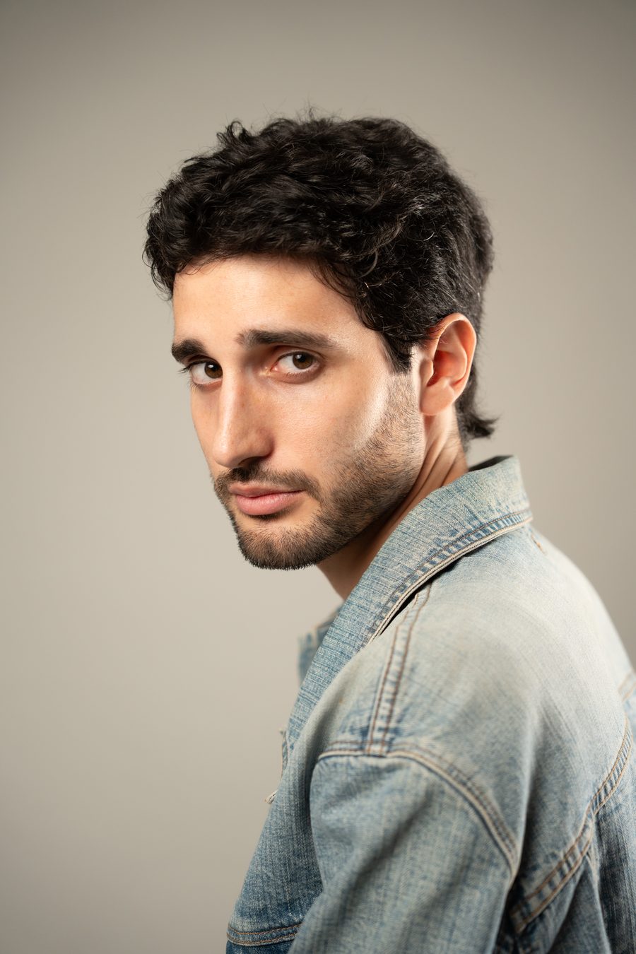 Jovan Penezić in profile, denim jacket.