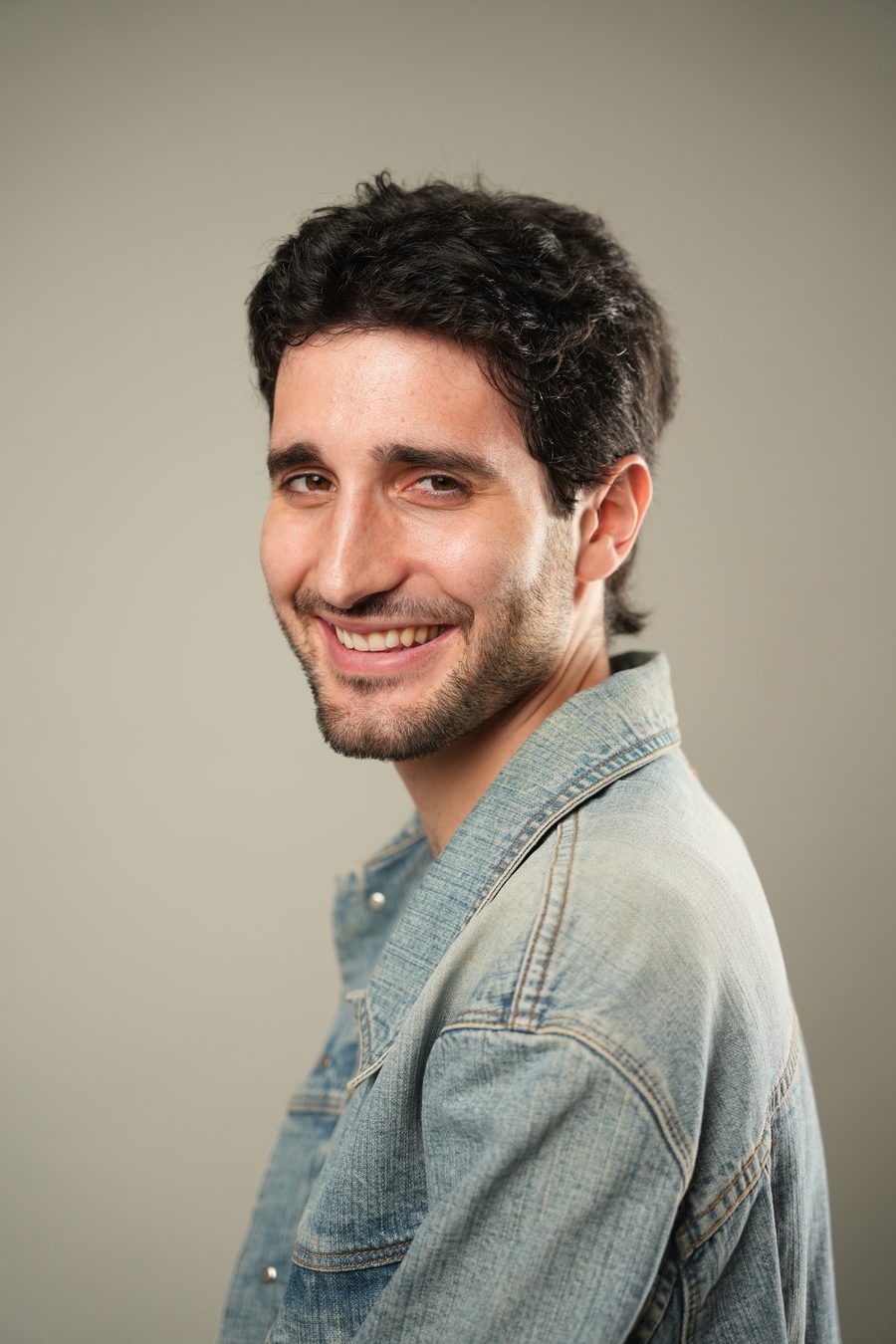 Jovan Penezić smiling, denim jacket.